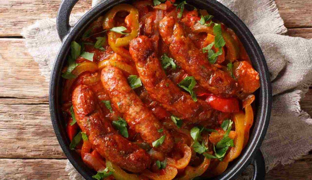 Salsicce e peperoni al pomodoro in padella | Cena perfetta per il weekend