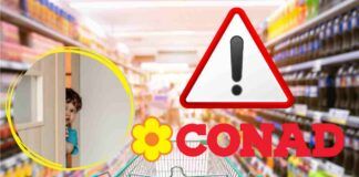 Carrello di un supermercato e il marchio Conad