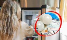 Donna davanti al frigo aperto
