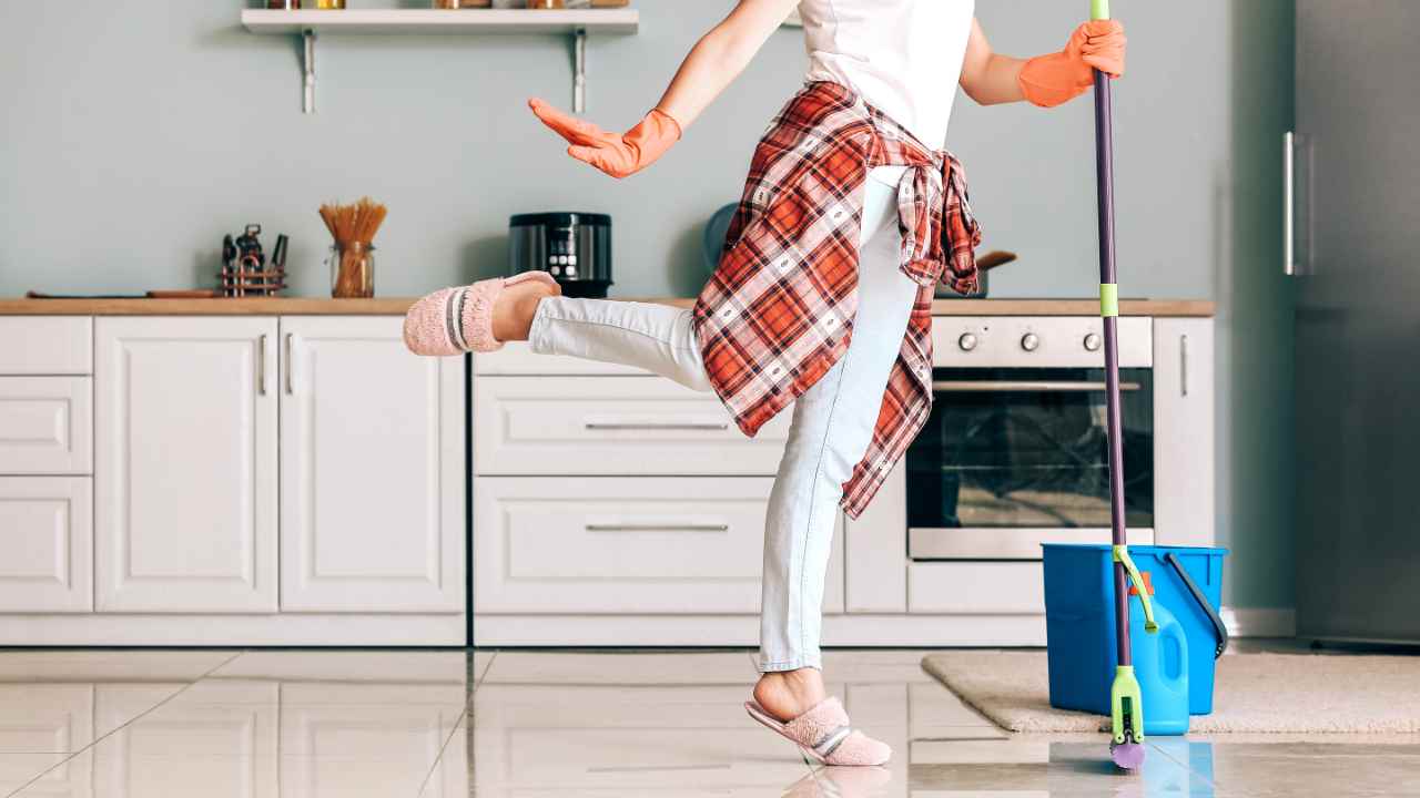 Donna che lava pavimento della cucina