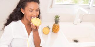 Donna che mangia ananas