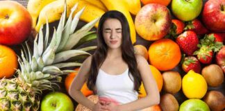 Una donna che soffre di colite su frutta che fa da sfondo