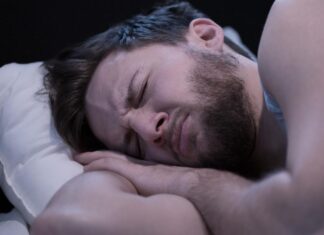 Un uomo che sta avendo degli incubi di notte