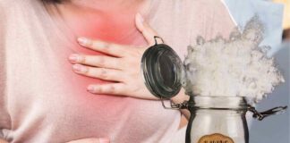 Una donna che soffre di acidità di stomaco e del bicarbonato