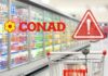 Un carrello con dei banchi frigo ed il logo Conad