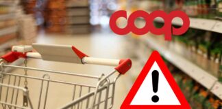 COOP richiamo urgente, c’è un pericolo invisibile nel carrello: “Rischio altissimo, non mangiarli” Carrello della spesa in supermercato con logo Coop e segnale di pericolo